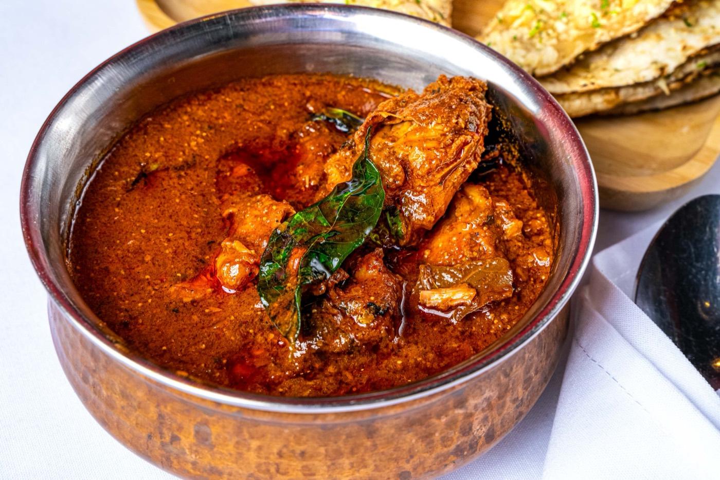 Spicy Halal Andhra-style chicken curry with curry leaves at India 101 in Irving, TX