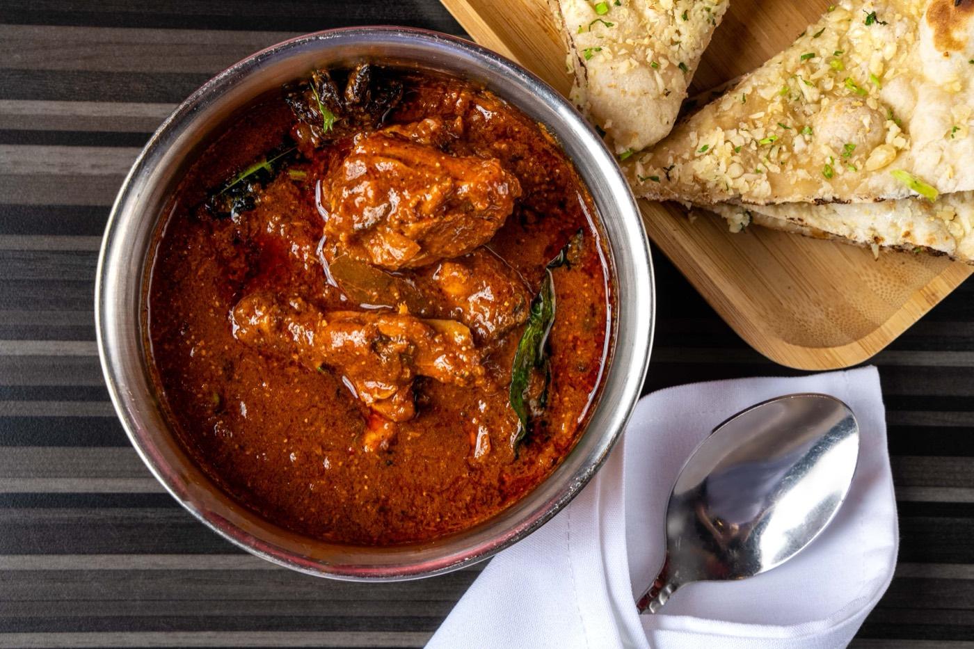 Andhra Halal chicken curry with curry leaves and garlic naan at India 101 in Irving, TX