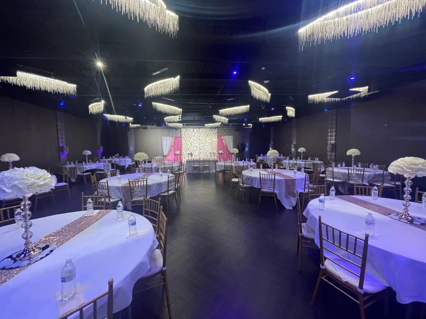 Ballroom with rose-gold sequin runners and tall rose centerpieces at India 101 banquet hall in Irving, TX