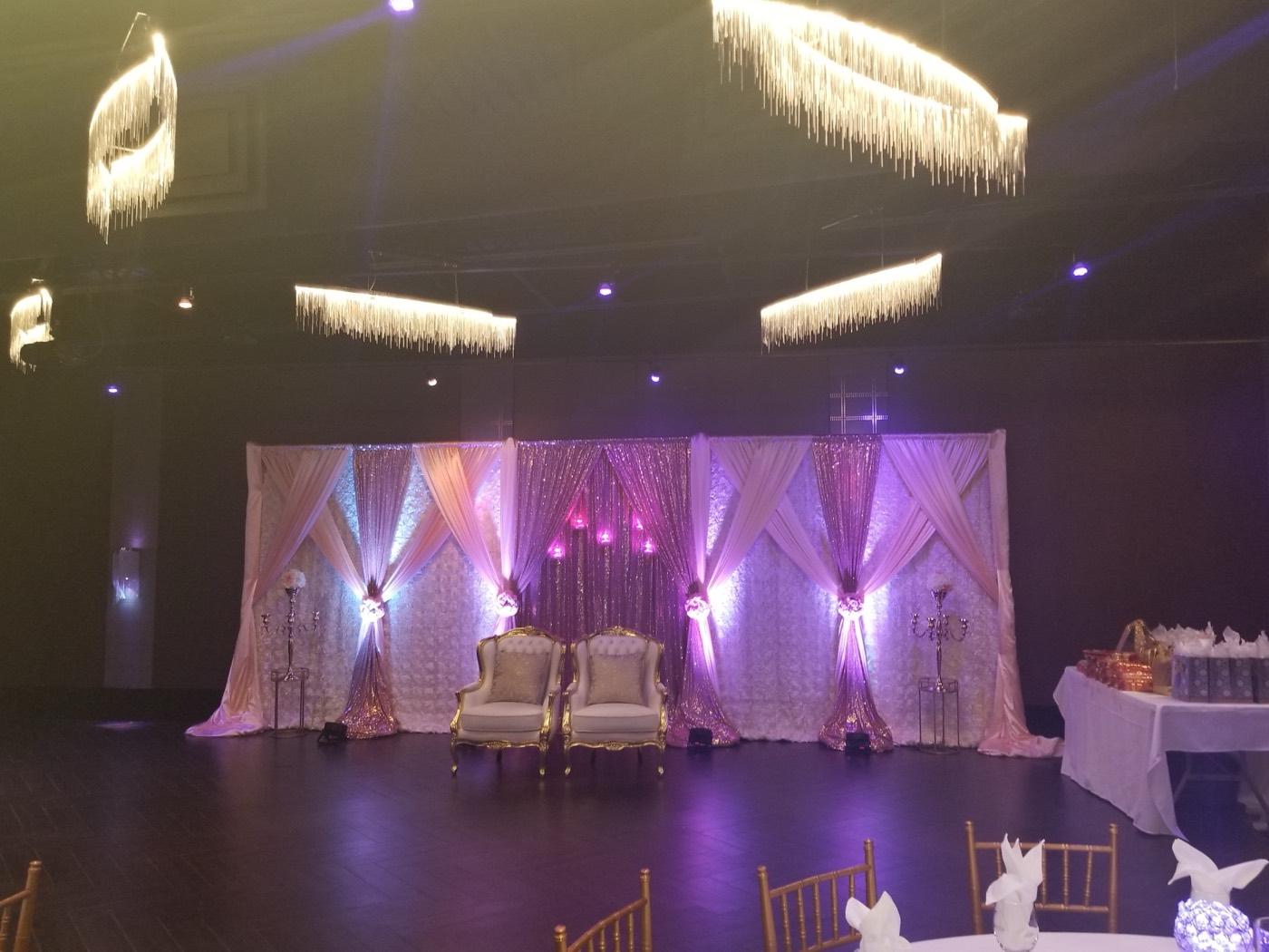 Blush and rose gold sequin draped stage with two throne chairs at India 101 banquet hall in Irving, TX