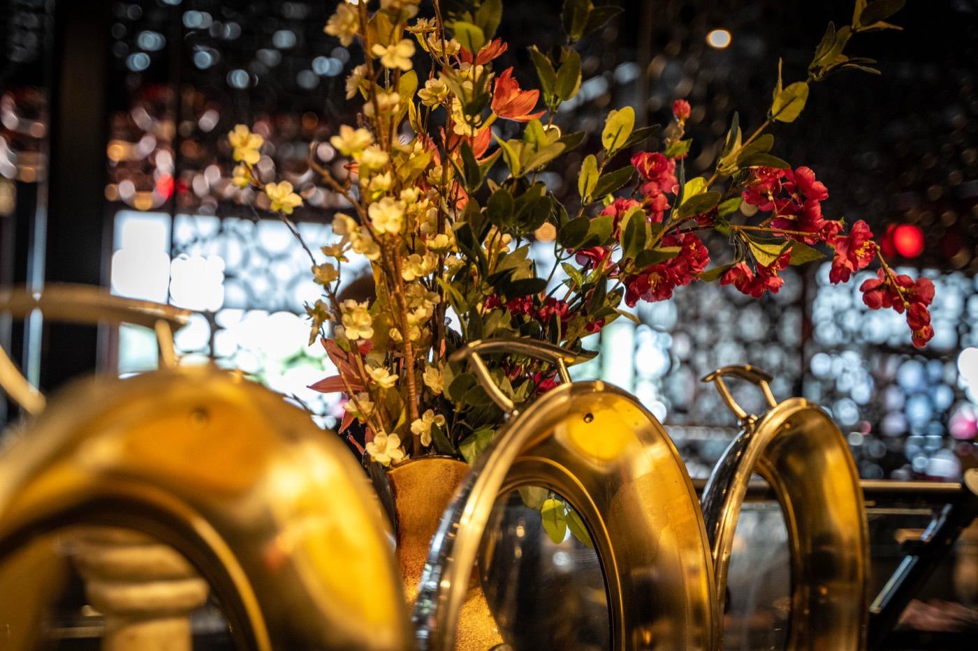 Brass chafing dishes and fresh floral centerpiece on the buffet at India 101 in Irving, TX