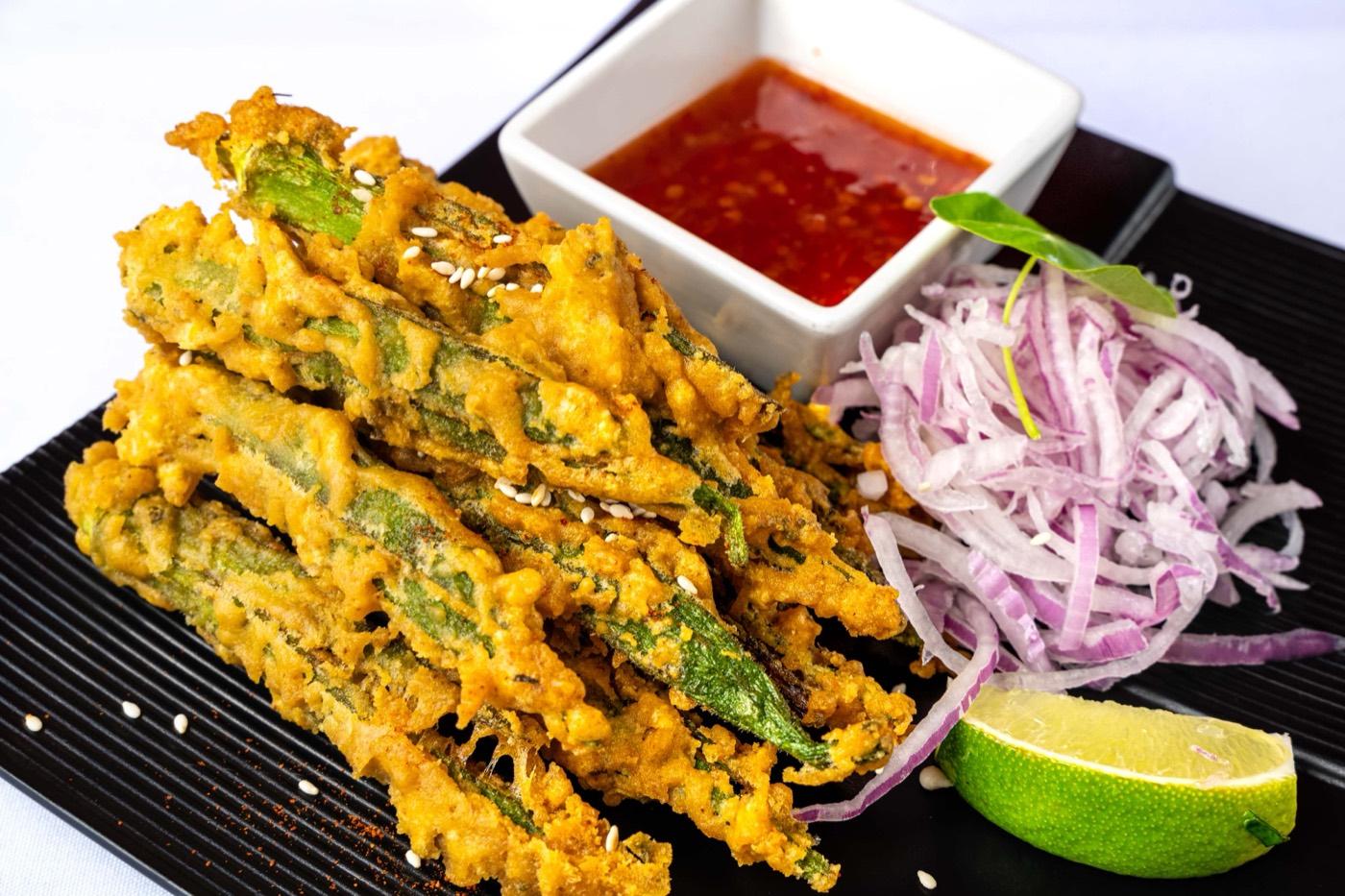 Close-up of sesame-topped crispy fried okra with sweet chili dip at India 101 in Irving, TX