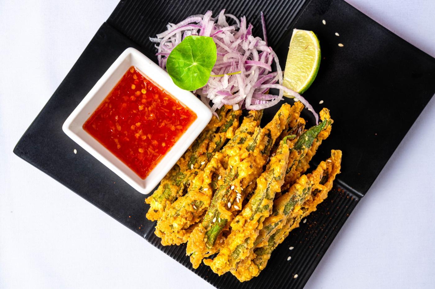 Vegetarian crispy fried okra with sweet chili dip, sliced onions and lime at India 101 in Irving, TX