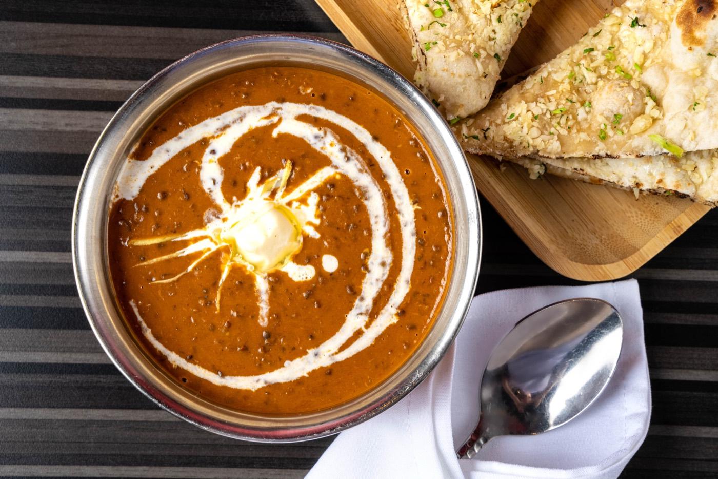 Creamy dal makhani black lentils with butter and garlic naan at India 101 in Irving, TX