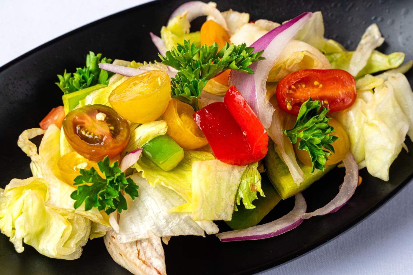 Close-up of fresh garden salad with tomatoes, peppers and onion at India 101 in Irving, TX