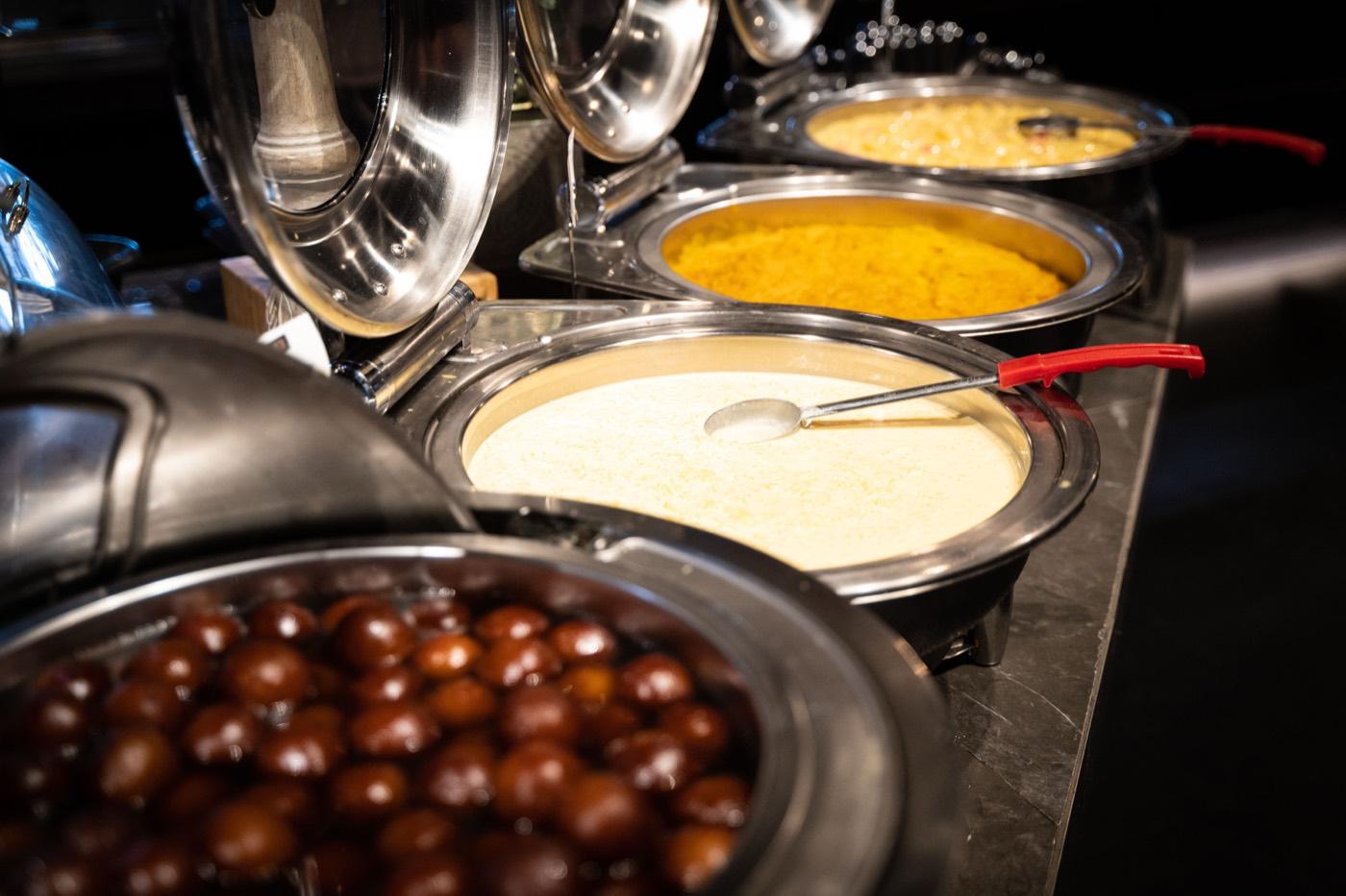 Buffet dessert line with gulab jamun, phirni and halwa at India 101 in Irving, TX