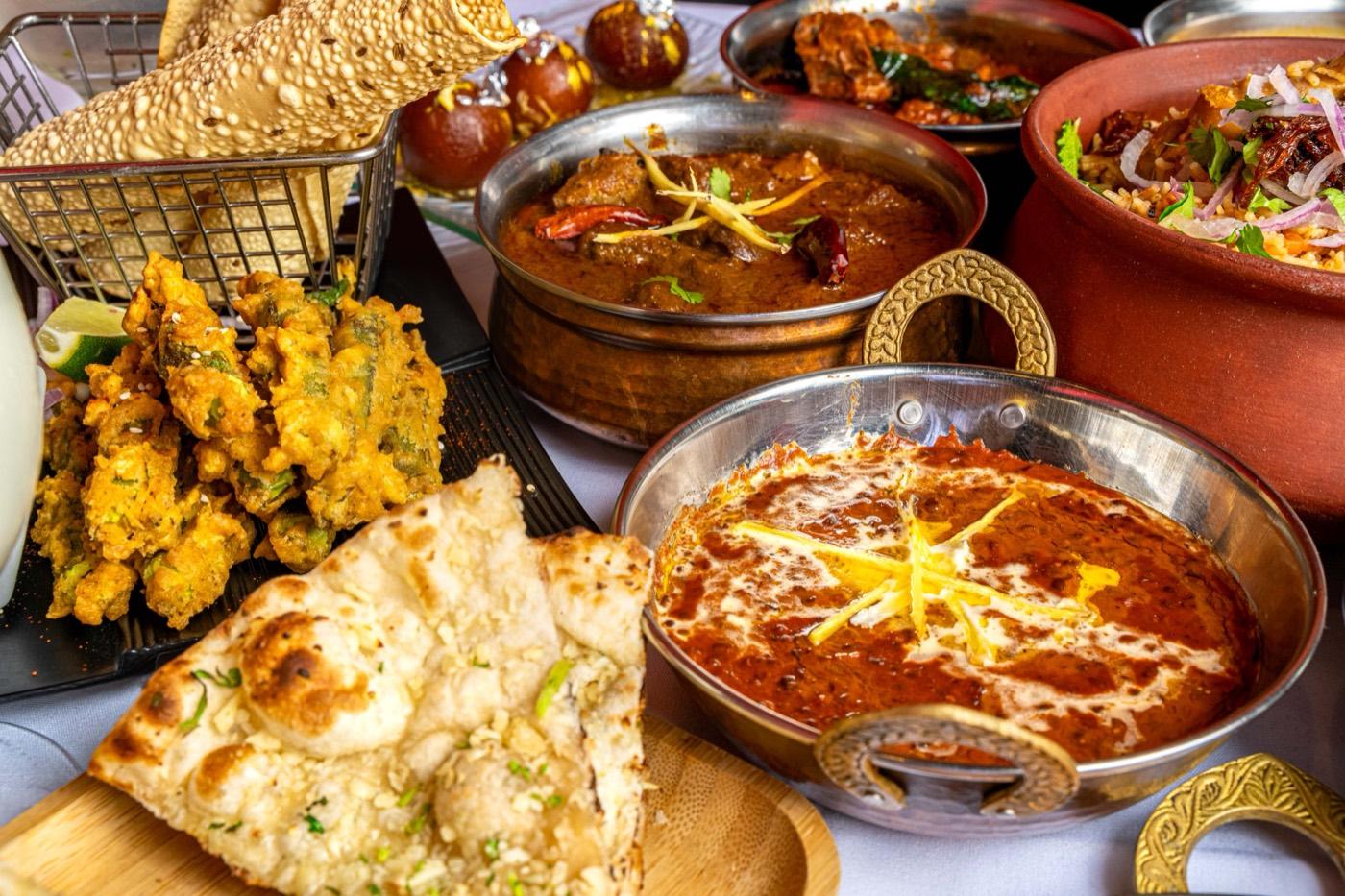 Halal North Indian feast with naan, pakora, and curries at India 101 in Irving, TX