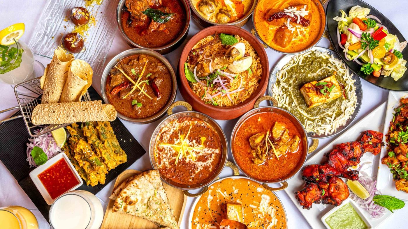 Colorful spread of Halal North Indian dishes with biryani, curries and tandoori at India 101 in Irving, TX