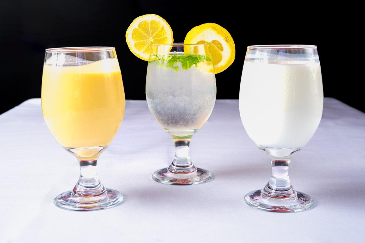 Trio of Indian drinks including mango lassi, lemon mint cooler and sweet lassi at India 101 in Irving, TX