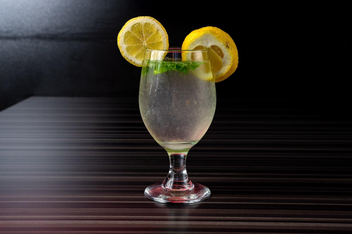 Refreshing lemon-mint cooler garnished with lemon slices at India 101 in Irving, TX