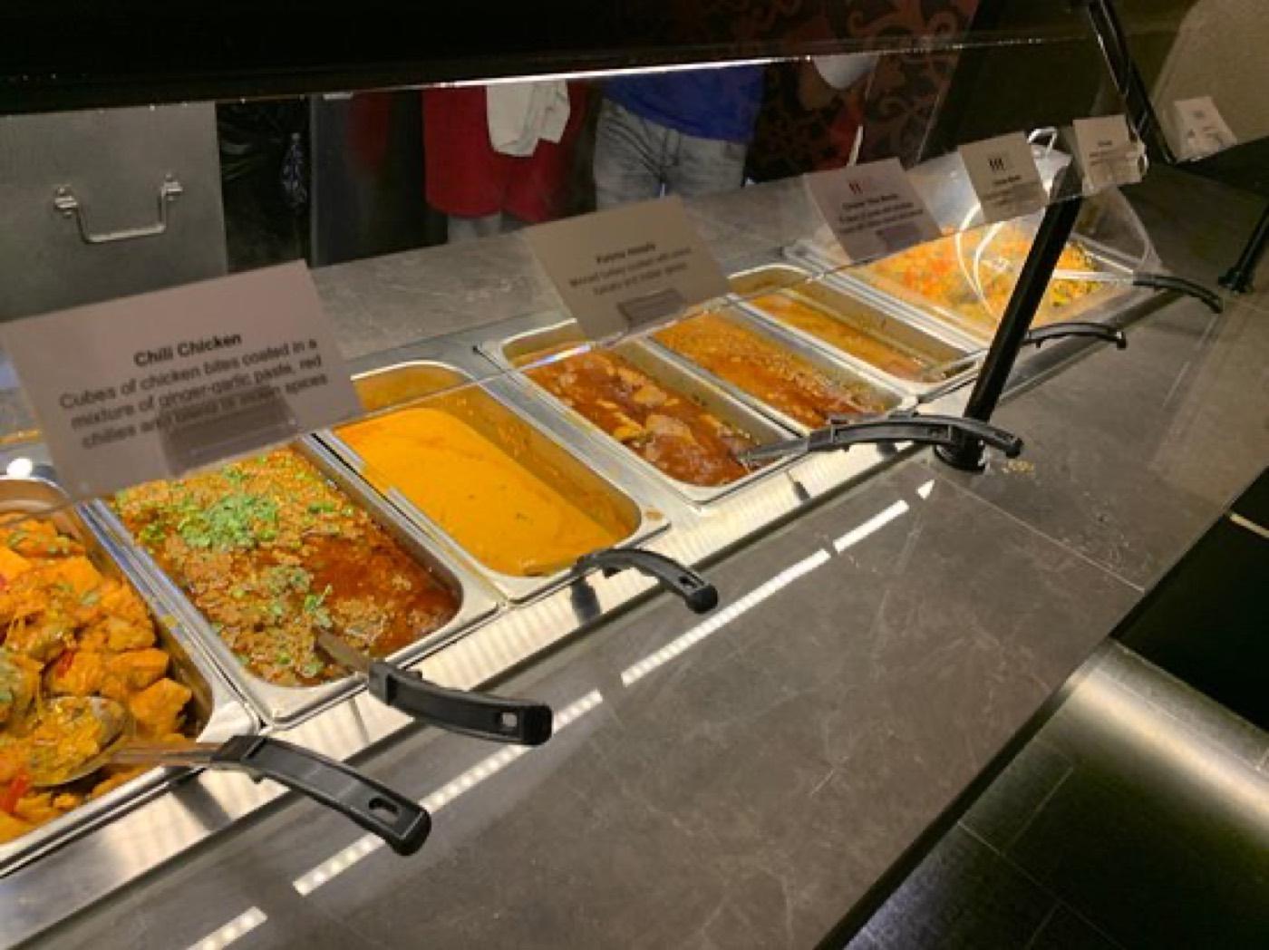 Labeled buffet trays including chili chicken at the India 101 buffet