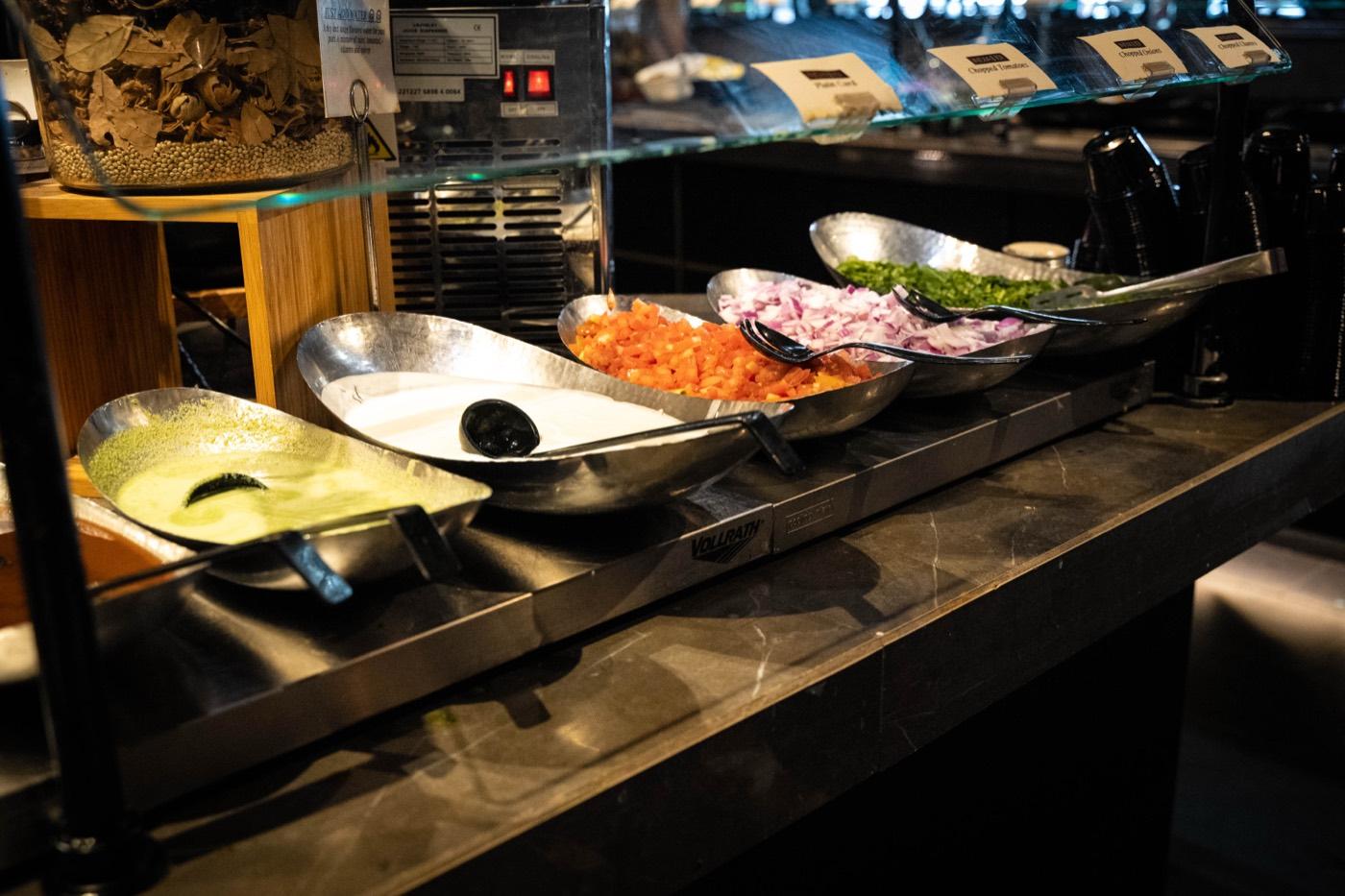 India 101 buffet chaat station with chutneys, onions and tomatoes in Irving, TX