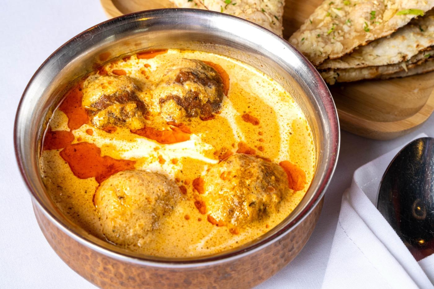 Close-up of malai kofta dumplings in cashew-cream gravy at India 101 in Irving, TX