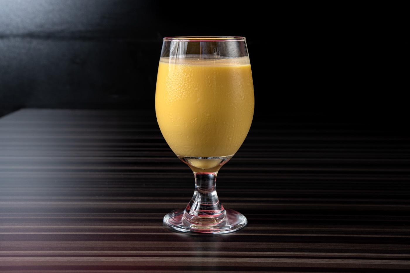 Glass of creamy mango lassi at India 101 in Irving, TX