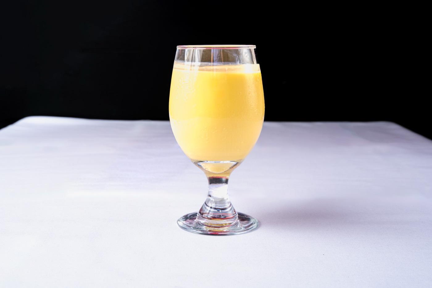 Glass of creamy mango lassi at India 101 in Irving, TX