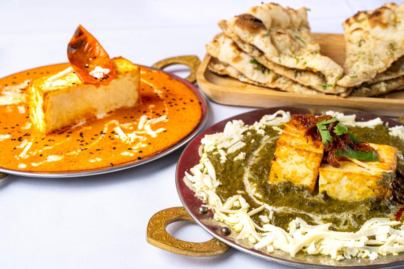 Close-up of makhani paneer and palak paneer with naan at India 101 in Irving, TX