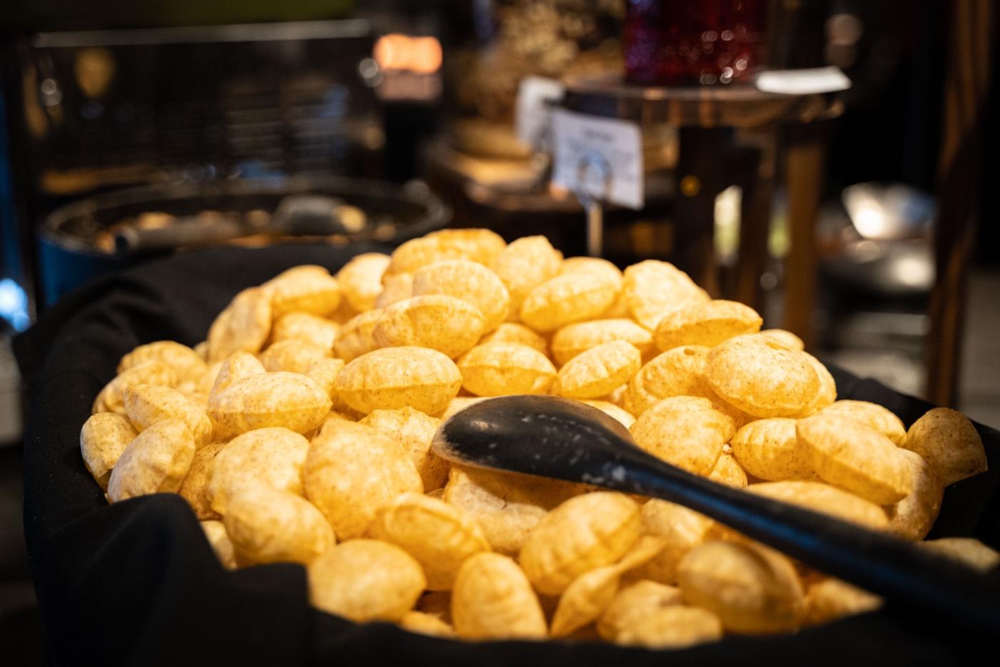 Basket of crispy golden pani puri shells at India 101 in Irving, TX