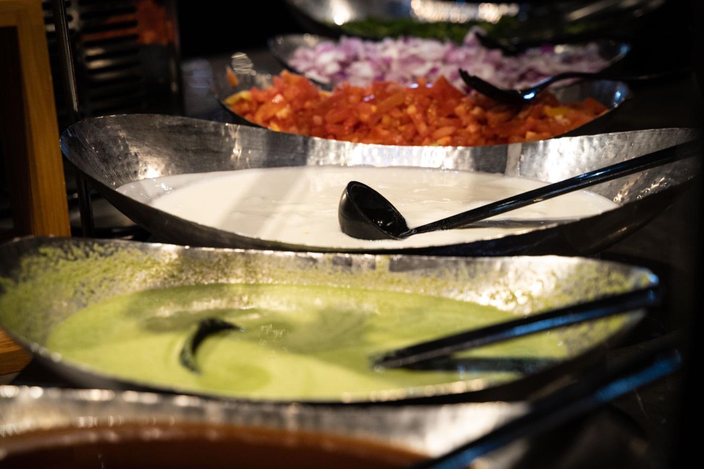 Yogurt raita, green chutney and chopped tomatoes at the India 101 buffet in Irving, TX
