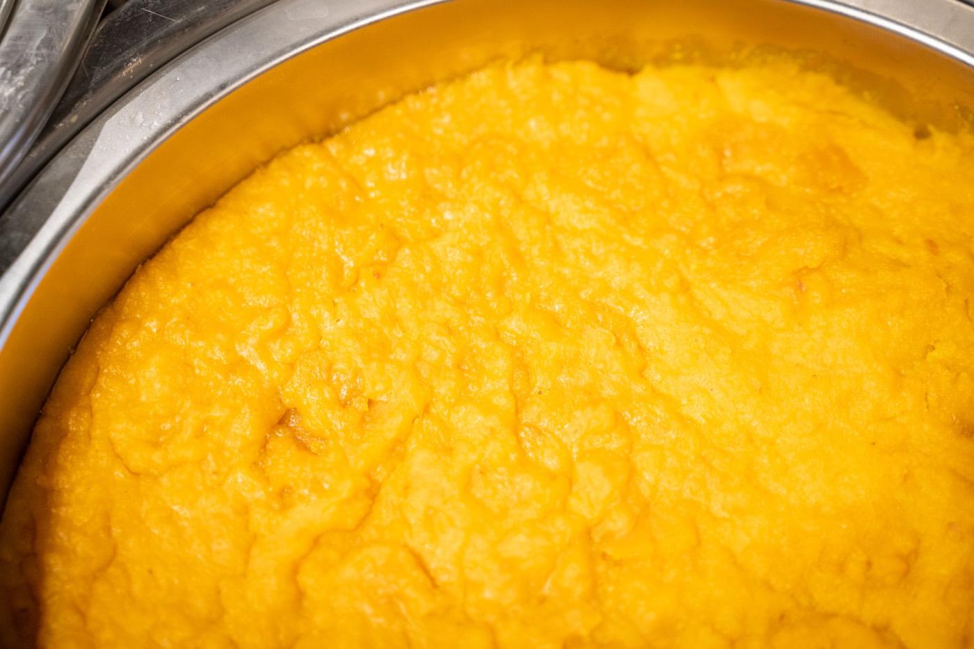 Chafer of bright saffron rava kesari semolina halwa at India 101 in Irving, TX