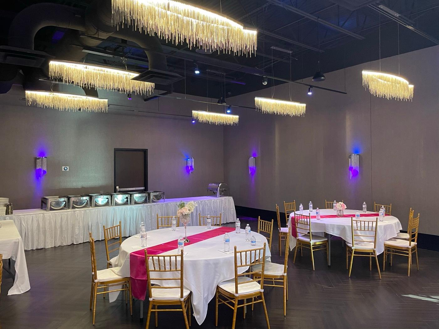 Reception tables with fuchsia runners and buffet chafing dishes at India 101 banquet hall in Irving, TX