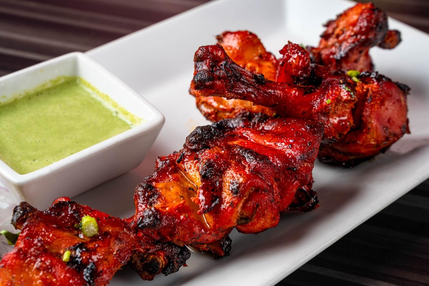 Smoky Halal tandoori chicken skewer with green mint chutney at India 101 in Irving, TX