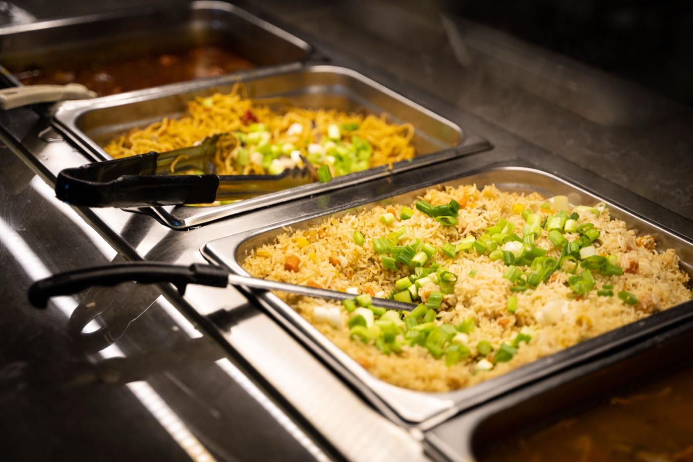 Buffet trays of veg Hakka noodles and fried rice with scallions at India 101 in Irving, TX