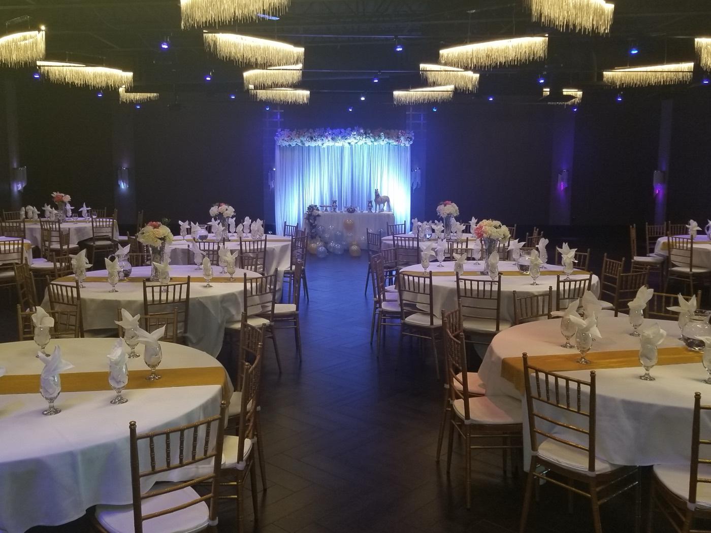 Elegant white and gold reception setup with floral head-table backdrop at India 101 banquet hall in Irving, TX