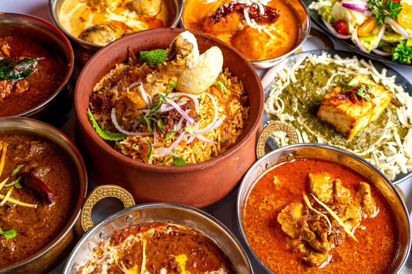 Halal clay-pot biryani with assorted North Indian curries at India 101 in Irving, TX