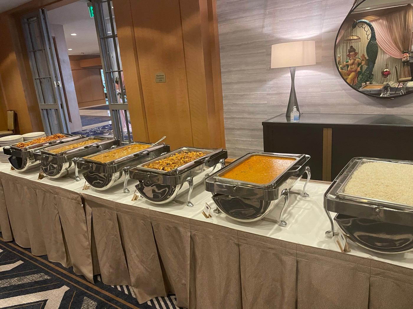 Chafing-dish catering line with curries, stir-fry, and steamed rice by India 101 in Irving, TX